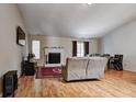 Inviting living room with a cozy fireplace, hardwood floors, and ample natural light at 3816 Cologne Ct, Indianapolis, IN 46228