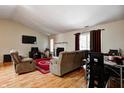 Comfortable living room featuring a fireplace, hardwood floors, and views of the backyard at 3816 Cologne Ct, Indianapolis, IN 46228