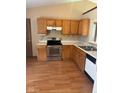 Kitchen with wood cabinets, stainless steel range, dishwasher, and white countertops at 39 Meadow Creek East Blvd, Whiteland, IN 46184