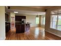 Spacious living room featuring hardwood floors and ample natural light from large windows at 4230 Raintree Blvd, Greenwood, IN 46143