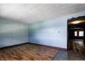 Spacious living room featuring wood-look flooring, blue walls, and an open doorway at 436 N 500 W, Anderson, IN 46011