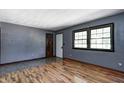 Comfortable living room with hardwood flooring and abundant natural light from a large window at 436 N 500 W, Anderson, IN 46011
