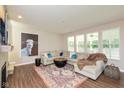 Comfortable living room featuring a cozy fireplace, large sectional sofa, and natural light at 4642 Boyd Pl, Westfield, IN 46062