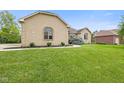 Well-maintained brick home with a spacious front yard and walkway at 5274 Brooks Bnd, Greenwood, IN 46143