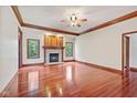 Bright living room featuring a stone fireplace, hardwood floors, and wood trim at 5274 Brooks Bnd, Greenwood, IN 46143