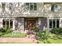 Up close view of the beautiful front entrance with lovely brickwork and luscious greenery at 54 Horseshoe Ln, Carmel, IN 46033