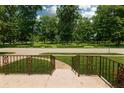 View from the porch with a well manicured lawn and mature trees at 5927 Meadowood Dr, Speedway, IN 46224