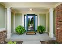 Charming front door entrance with plants and great curb appeal at 6118 Deerwood Dr, Greenwood, IN 46143