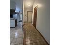 Inviting hallway featuring tiled flooring leading to the kitchen and front door at 613 Monte Vista Dr, Greenwood, IN 46143