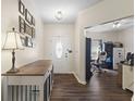 Inviting entryway featuring dark wood floors and stylish decor at 6563 Enclave Blvd, Greenwood, IN 46143