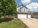 Attractive home with a well-manicured lawn, brick accents, and an attached two-car garage at 6563 Enclave Blvd, Greenwood, IN 46143