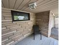 A covered porch features stone accents and seating, creating a welcoming outdoor space at 7150 Combs Rd, Indianapolis, IN 46237