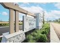Hampton Walk community entrance sign with lush landscaping and manicured greenery at 7284 Bayview Run, McCordsville, IN 46055