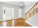 Spacious foyer with wood floors, staircase, and a view of the front door at 7337 Wythe Dr, Noblesville, IN 46062