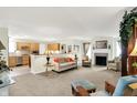 Open-concept living room with a fireplace and views into the kitchen at 8038 Sydney Ln, Avon, IN 46123