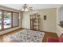 Bright living room featuring hardwood floors, large windows, and a ceiling fan, creating a comfortable and inviting space at 8217 S Talbott Ave, Indianapolis, IN 46227