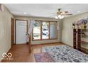 Bright living room featuring wood floors, large windows, and a ceiling fan, creating a comfortable and inviting space at 8217 S Talbott Ave, Indianapolis, IN 46227