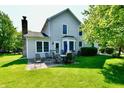 The home has an outdoor patio featuring outdoor furniture, mature trees, and a well-manicured lawn at 8460 Brittany N Ct, Indianapolis, IN 46236