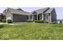 Lovely brick home boasting lush green lawn, inviting facade, and ample space for comfortable suburban living at 8864 S Tibbs Ave, Indianapolis, IN 46217