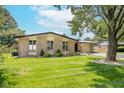 Well-maintained brick home with mature landscaping, healthy green lawn, and inviting outdoor space at 10622 Penn Dr, Indianapolis, IN 46280