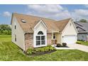 Lovely home showcasing a blend of brick and siding, with a lush green lawn and driveway at 11320 Lynchburg Way, Indianapolis, IN 46229
