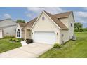 A well-maintained property with a spacious two-car garage, complemented by a beautiful lawn at 11320 Lynchburg Way, Indianapolis, IN 46229