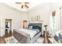 Elegant main bedroom features tray ceilings, recessed lighting, a gray upholstered bed frame, and ample natural light at 117 Sawgrass Ct, Lebanon, IN 46052