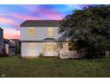 This home features a cozy back yard with well-kept lawn at 11961 Driftstone Dr, Fishers, IN 46037