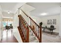 Inviting entryway featuring hardwood floors, staircase, and a view into the adjacent rooms with natural light at 11961 Driftstone Dr, Fishers, IN 46037