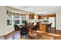 Cozy kitchen and dining area with oak cabinets, modern appliances, and a large bay window at 11961 Driftstone Dr, Fishers, IN 46037