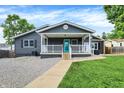 Charming one-story home with a grey exterior, inviting covered front porch and walkway at 121 Ursal Ln, Greenwood, IN 46143