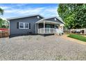 Charming one-story home with a grey exterior, inviting covered front porch and walkway at 121 Ursal Ln, Greenwood, IN 46143