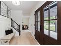 Bright entryway with stylish bench seating, wood floors, and staircase access at 12118 Castle Row Overlook, Carmel, IN 46033