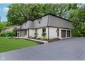 Spacious home with attached garage, stone accents, covered entryway, and a large driveway at 12118 Castle Row Overlook, Carmel, IN 46033