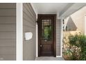 Close-up of a charming wood front door with glass detail and a white mailbox at 1217 Newman St, Indianapolis, IN 46201