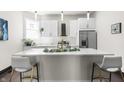 Bright, modern kitchen featuring white cabinets, stainless steel appliances, and a quartz countertop island at 1217 Newman St, Indianapolis, IN 46201