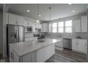 Bright kitchen featuring white cabinets, stainless steel appliances, and a center island at 13448 Mosaic St, Fishers, IN 46037