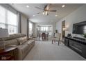 Spacious living room with hardwood floors, a ceiling fan, and plenty of natural light at 13448 Mosaic St, Fishers, IN 46037