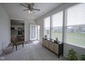 Bright sunroom with large windows, neutral carpet, and an exterior door at 13448 Mosaic St, Fishers, IN 46037