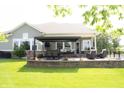 Backyard patio with pergola, outdoor seating, dining area, and well-maintained lawn at 13820 Woodside Hollow Dr, Carmel, IN 46032