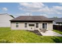 A spacious backyard featuring a patio with outdoor seating, perfect for relaxing and entertaining at 15308 Wolf Run Ct, Noblesville, IN 46060
