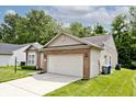 Pleasant suburban home with well-maintained landscaping and a two-car garage, nestled in a quiet neighborhood at 15308 Wolf Run Ct, Noblesville, IN 46060