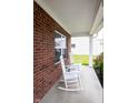 Relaxing front porch featuring classic white rocking chairs at 1792 Persimmon Grove Dr, Indianapolis, IN 46234