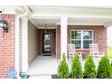 Inviting front porch with rocking chairs and a charming entrance at 1792 Persimmon Grove Dr, Indianapolis, IN 46234