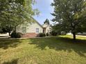 View of a well-manicured lawn and charming two-story house with a combination of siding and brick exterior at 19409 Mimosa Ct, Noblesville, IN 46060