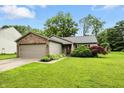 Inviting single-story home featuring lush green lawn and mature trees at 19433 Tradewinds Dr, Noblesville, IN 46062