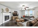 Comfortable living room featuring a cozy fireplace and plush seating at 19433 Tradewinds Dr, Noblesville, IN 46062