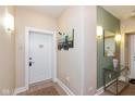 Cozy entrance hall featuring an art piece, sconces and neutral walls at 2105 N Meridian St # 203, Indianapolis, IN 46202