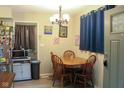 Cozy dining area featuring a wooden table with four chairs, a chandelier, and natural light at 219 N 9Th Ave, Beech Grove, IN 46107