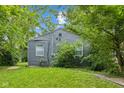 The backyard has a well kept lawn and a home featuring grey siding at 2359 N Gale St, Indianapolis, IN 46218